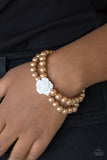 Posh and Posy - Brown - Paparazzi Accessories -  Connected by a flirty white resin rose, classic brown pearls are threaded along stretchy bands around the wrist for a vintage inspired fashion.  Sold as one individual bracelet
