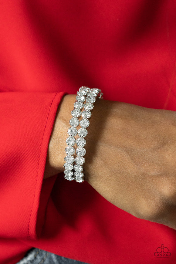 Megawatt Majesty - White - Paparazzi Accessories -   Item #P9RE-WTXX-174XX Encased in sleek silver fittings, two oversized rows of glassy white rhinestones stack into a blinding cuff around the wrist for a jaw-dropping look.  Sold as one individual bracelet.