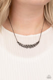 Whatever Floats Your YACHT - Black - Paparazzi Accessories -  Item #P2DA-BKXX-136XX Encrusted in glassy white rhinestones, studded gunmetal bars braid into a bowing pendant below the collar for a refined fashion. Features an adjustable clasp closure.  Sold as one individual necklace. Includes one pair of matching earrings.