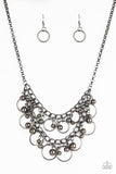 Item #P2IN-BKXX-148XX Brushed in a high-sheen finish, mismatched gunmetal beads and airy gunmetal hoops swing from two rows of gunmetal chains, creating an edgy fringe below the collar. Features an adjustable clasp closure.  Sold as one individual necklace. Includes one pair of matching earrings.