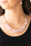 One-WOMAN Show - Pink - Paparazzi Accessories -  Item #P2RE-PKXX-169XX Oversized pink pearls and crystal-like beads give way to layers of beaded pearl strands below the collar for a timeless look. Features an adjustable clasp closure.  Sold as one individual necklace. Includes one pair of matching earrings.