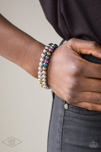 Chroma Color - Multi - Paparazzi Accessories -  Item #P9RE-MTXX-057XX Dipped in a rainbow iridescence, a collection of metallic crystal-like beads and shiny silver beads are threaded along two stretchy bands around the wrist for a stellar look.  Sold as one set of two bracelets.  This was a "Bring Back" piece for Black Diamond - Life of the Party!