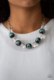 Torrid Tide - Blue - Paparazzi Accessories -  A collection of shiny black and glassy clear beads are threaded along an invisible wire below the collar. The black beads are splashed in hints of refreshing blue and shiny metallic paint for a colorful finish. Features an adjustable clasp closure.  Sold as one individual necklace. Includes one pair of matching earrings.