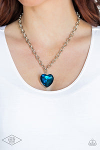 Flirtatiously Flashy - Blue - Paparazzi Accessories -  Item #P2WH-BLXX-391XX Set atop a sleek silver fitting, a glittery blue heart-shaped gem swings from the bottom of a classic silver chain below the collar for a whimsical look. Features an adjustable clasp closure.  Sold as one individual necklace. Includes one pair of matching earrings.