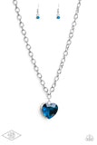 Flirtatiously Flashy - Blue - Paparazzi Accessories -  Item #P2WH-BLXX-391XX Set atop a sleek silver fitting, a glittery blue heart-shaped gem swings from the bottom of a classic silver chain below the collar for a whimsical look. Features an adjustable clasp closure.  Sold as one individual necklace. Includes one pair of matching earrings.