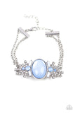 Brilliantly Boho - Blue - Paparazzi Accessories -  Item #P9WH-BLXX-226XX Dotted with opaque blue and white beads, white rhinestone encrusted silver frames flare out from a dewy blue beaded center. Two dainty silver chains attach to the colorful centerpiece for a whimsically layered look. Features an adjustable clasp closure.  Sold as one individual.