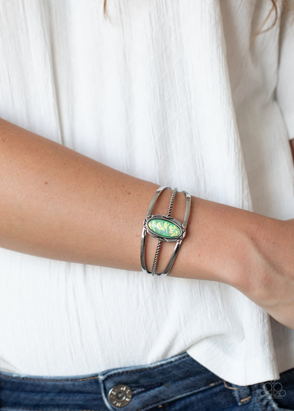 Stone Sahara - Green - Paparazzi Accessories -   Item #P9WH-GRXX-157XX A glittery green stone is pressed into a decorative silver frame atop a mismatched layered cuff, creating a seasonal sparkle around the wrist.  Sold as one individual bracelet.