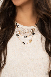 Downtown Reflections - Gold - Paparazzi Accessories -  Item #P2RE-GDXX-311XX Featuring a decorative surface, dainty gold, gunmetal, and silver rectangular accents are fitted in place along three sleek gold chains, creating refined layers below the collar. Features an adjustable clasp closure.  Sold as one individual necklace. Includes one pair of matching earrings.