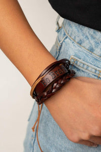 Brave Soul - Brown - Paparazzi Accessories -   Mismatched strands of brown twine and leather cords join a thick brown leather band stamped in the phrase, "Be Brave," around the wrist for a rustically layered look. Features an adjustable sliding knot closure.  Sold as one individual bracelet.