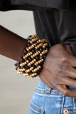 Cozy in Cozumel - Brown - Paparazzi Accessories -  Item #P9SE-BNXX-156XX A collection of dainty tan wooden beads and brown wooden discs are threaded along knotted stretchy bands, creating a tropical floral pattern around the wrist.  Sold as one individual bracelet.