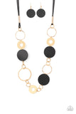 Sooner or LEATHER - Black - Paparazzi Accessories -  Item #P2WH-BKXX-264XX A shiny collection of mismatched gold rings and textured hoops link with round pieces of black leather across the chest for a whimsically retro look. The colorful compilation attaches to layered strands of shiny black cording for a trendy finish. Features an adjustable clasp closure.  Sold as one individual necklace. Includes one pair of matching earrings.