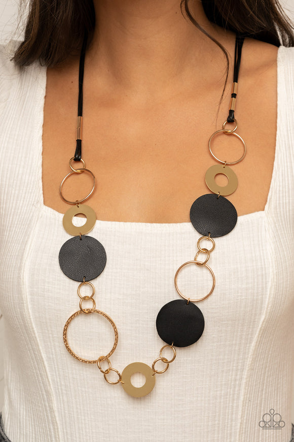 Sooner or LEATHER - Black - Paparazzi Accessories -  Item #P2WH-BKXX-264XX A shiny collection of mismatched gold rings and textured hoops link with round pieces of black leather across the chest for a whimsically retro look. The colorful compilation attaches to layered strands of shiny black cording for a trendy finish. Features an adjustable clasp closure.  Sold as one individual necklace. Includes one pair of matching earrings.