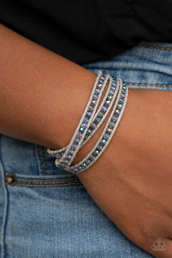 What Goes Around - Multi - Paparazzi Accessories -  Item #P9SE-MTXX-132XX .A dainty collection of iridescent crystal-like beads are delicately threaded between two strands of shiny gray cording, coalescing into a trendy double wrap bracelet around the wrist. Features an adjustable button loop closure.  Sold as one individual bracelet. LIFE OF THE PARTY (LOP)