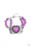 Sandstone Sweetheart - Purple - Paparazzi Accessories -   Item #P9SE-PRXX-113XX Threaded along invisible wire, strands of purple rock beads and dainty silver accents attach to a shimmery silver plate radiating with linear and studded textures. Chiseled into a charming heart, a purple stone adorns the center of the frame for a flirty finish. Features an adjustable clasp closure.  Sold as one individual bracelet.