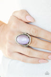 Happily Ever Enchanted - Purple - Paparazzi Accessories -  Item #P4RE-PRXX-148XX An oval Amethyst Orchid cat's eye stone is nestled inside a ring of white rhinestones featuring dainty heart details, creating a charming centerpiece atop the finger. Features a stretchy band for a flexible fit.  Sold as one individual ring.