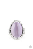 Happily Ever Enchanted - Purple - Paparazzi Accessories -  Item #P4RE-PRXX-148XX An oval Amethyst Orchid cat's eye stone is nestled inside a ring of white rhinestones featuring dainty heart details, creating a charming centerpiece atop the finger. Features a stretchy band for a flexible fit.  Sold as one individual ring.