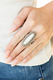 Mystical Mesa - White - Paparazzi Accessories -   Item #P4SE-WTXX-144XX An oblong white stone adorns the center of an elongated silver frame featuring mismatched silver textures for a bold artisan look. Features a stretchy band for a flexible fit.  Sold as one individual ring.