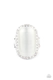 Thank Your LUXE-y Stars - White - Paparazzi Accessories -  Item #P4RE-WTXX-410XX An oversized white cat's eye stone sits atop an icy silver frame bedazzled in blinding white rhinestones for a luxurious look. Features a stretchy band for a flexible fit.  Sold as one individual ring.