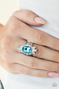 Icy Icon - Blue - Paparazzi Accessories -  Item #P4RE-BLXX-212XX An icy collection of round, marquise, and emerald style white rhinestones radiate out from a blue gem center, creating a glamorous centerpiece atop the finger. Features a stretchy band for a flexible fit.  Sold as one individual ring.