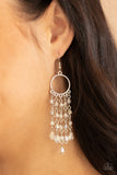 Dazzling Delicious - White - Paparazzi Accessories -  Item #P5RE-WTXX-486XX Glittery rows of iridescent white crystal-like beads stream from the bottom of a dainty silver hoop, creating a dazzling chandelier. Earring attaches to a standard fishhook fitting.  Sold as one pair of earrings.