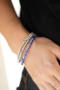 Elegant Essence - Blue - Paparazzi Accessories -   Item #P9DA-BLXX-083XX A pair of faceted silver beaded bracelets join a strand of glassy blue emerald style beads around the wrist, creating iridescently stretchy layers.  Sold as one set of three bracelets.