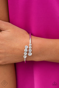 Defying Dazzle - White - Paparazzi Accessories -  Item #P9RE-WTXX-441XU Attached to two thick silver bars, oversized rows of glittery white rhinestones delicately stack into a hypnotizing centerpiece around the wrist. Features a hinge closure.  Sold as one individual bracelet.