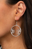 Demurely Daisy - Silver - Paparazzi Accessories -   Item #P5WH-SVXX-226XX A pair of airy daisies bloom inside a hammered silver hoop, creating a whimsically seasonal display. Earring attaches to a standard fishhook fitting.  Sold as one pair of earrings.