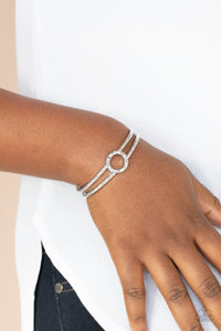 Historical Heirloom - Silver - Paparazzi Accessories -  Item #P9BA-SVXX-097XX Featuring a hammered circle centerpiece, imperfect silver bars connect into a rustic cuff around the wrist.  Sold as one individual bracelet.