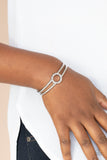 Historical Heirloom - Silver - Paparazzi Accessories -  Item #P9BA-SVXX-097XX Featuring a hammered circle centerpiece, imperfect silver bars connect into a rustic cuff around the wrist.  Sold as one individual bracelet.