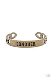 Item #P9MN-URBR-016XX Brass chain-like bars attach to a rustic brass centerpiece stamped in the powerful word, "CONQUER," creating a statement-making cuff around the wrist.  Sold as one individual bracelet.