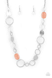 Colorful Combo - Orange - Paparazzi Accessories -   Item #P2WH-OGXX-214XX Infused with glassy coral accents, a shiny series of asymmetrical hoops and discs delicately link across the chest for a flirty pop of color. Features an adjustable clasp closure.  Sold as one individual necklace. Includes one pair of matching earrings.