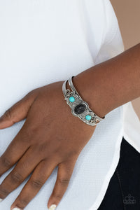 Artisan Ancestry - Black - Paparazzi Accessories -  Item #P9SE-BKXX-248XX Dotted with a pair of turquoise stone beads, silver floral filigree blooms out from an oval black stone centerpiece atop a studded silver cuff.  Sold as one individual bracelet.