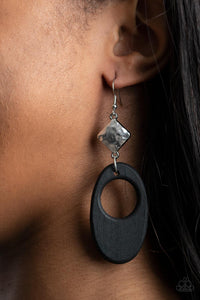 Retro Reveal - Black - Paparazzi Accessories -  Item #P5SE-BKXX-216XX An airy black wooden oval frame swings from the bottom of a hammered silver frame, creating a retro lure. Earring attaches to a standard fishhook fitting.  Sold as one pair of earrings.