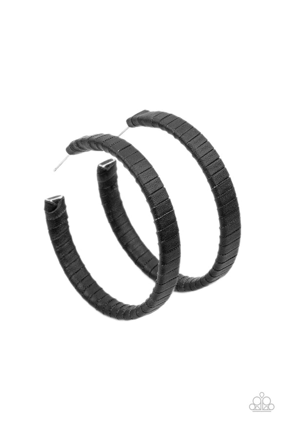 Leather-Clad Legend - Black - Paparazzi Accessories -  Item #P5HO-BKXX-205XX A black leather lace wraps around a thick silver hoop, creating an edgy display. Earring attaches to a standard post fitting. Hoop measures approximately 2 1/2