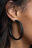 Leather-Clad Legend - Black - Paparazzi Accessories -  Item #P5HO-BKXX-205XX A black leather lace wraps around a thick silver hoop, creating an edgy display. Earring attaches to a standard post fitting. Hoop measures approximately 2 1/2" in diameter.  Sold as one pair of hoop earrings.