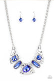 Futuristic Fashionista - Blue - Paparazzi Accessories -  Item #P2ST-BLXX-138XX Mismatched French Blue gems adorn the front of hammered silver plates that abstractly connect below the collar, creating an out-of-this-world statement piece. Features an adjustable clasp closure.  Sold as one individual necklace. Includes one pair of matching earrings.