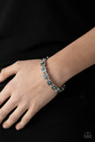 Cosmic Conquest - Blue - Paparazzi Accessories -  Item #P9WH-BLXX-245XX Dotted with iridescent blue rhinestone centers, studded silver frames alternate with pairs of dainty silver beads along stretchy bands, creating a stellar centerpiece around the wrist.  Sold as one individual bracelet.