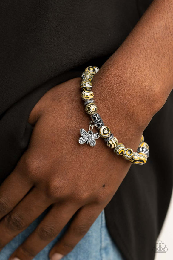 Butterfly Wishes - Yellow - Paparazzi Accessories -   Item #P9SE-URYW-067XX Swirling with yellow, black, and white accents, colorful stone beads and ornate silver accents are threaded along stretchy bands around the wrist. A dainty silver butterfly charm dangles from the display, adding a whimsical flair.  Sold as one individual bracelet.