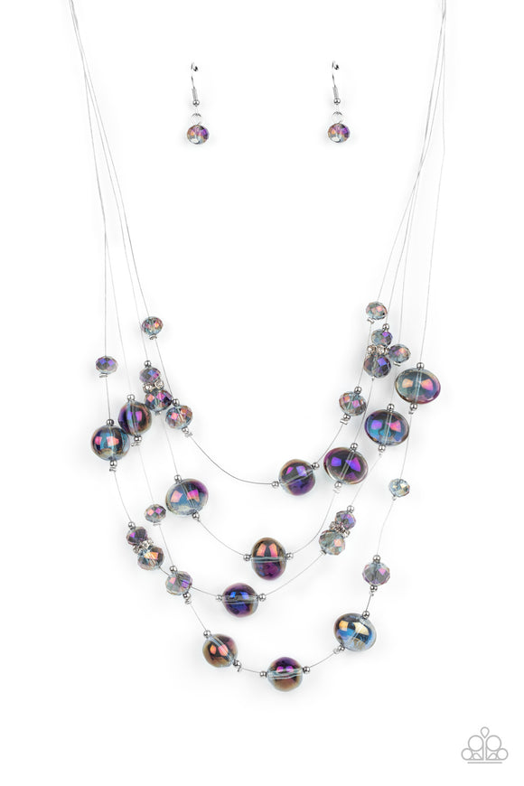 Cosmic Real Estate - Multi - Paparazzi Accessories -  Item #P2SE-MTXX-208XX Featuring an oil spill finish, glassy beads and faceted crystal-like accents are fitted in place along dainty wires, creating the illusion of floating layers below the collar. Dainty silver beads and white rhinestone encrusted silver rings sporadically embellish the stellar display for a timeless finish. Features an adjustable clasp closure.  Sold as one individual necklace. Includes one pair of matching earrings.