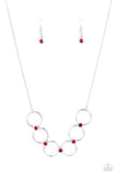 Regal Society - Red - Paparazzi Accessories -  Item #P2RE-RDXX-195XX Fiery red rhinestones link a dainty row of silver rings below the collar, creating a regal minimalist inspired display. Features an adjustable clasp closure.  Sold as one individual necklace. Includes one pair of matching earrings.