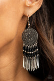 Sun Warrior - Black - Paparazzi Accessories -  Item #P5SE-BKXX-228XX Silver and black beaded tassels swing from the bottom of an oversized silver disc embossed in an antiqued sunburst. Flared silver bars attach to the bottoms of the beaded tassels, creating an edgy fringe. Earring attaches to a standard fishhook fitting.  Sold as one pair of earrings.