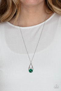 Gala Gleam - Green - Paparazzi Accessories -  Item #P2RE-GRXX-233XX Two silver teardrops delicately overlap in a solitaire pendant at the bottom of a shiny silver chain. A dainty white rhinestone dots the bottom of the highest teardrop, while an oversized green gem adorns the lowermost teardrop, coalescing into a sparkly centerpiece. Features an adjustable clasp closure.  Sold as one individual necklace. Includes one pair of matching earrings.