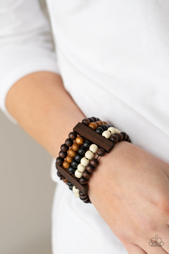 Caribbean Catwalk - Multi - Paparazzi Accessories -   Item #P9SE-MTXX-157XX Held in place by rectangular wooden frames, strands of brown, black, and white wooden beads are threaded along stretchy bands around the wrist for a colorfully tropical look.  Sold as one individual bracelet.