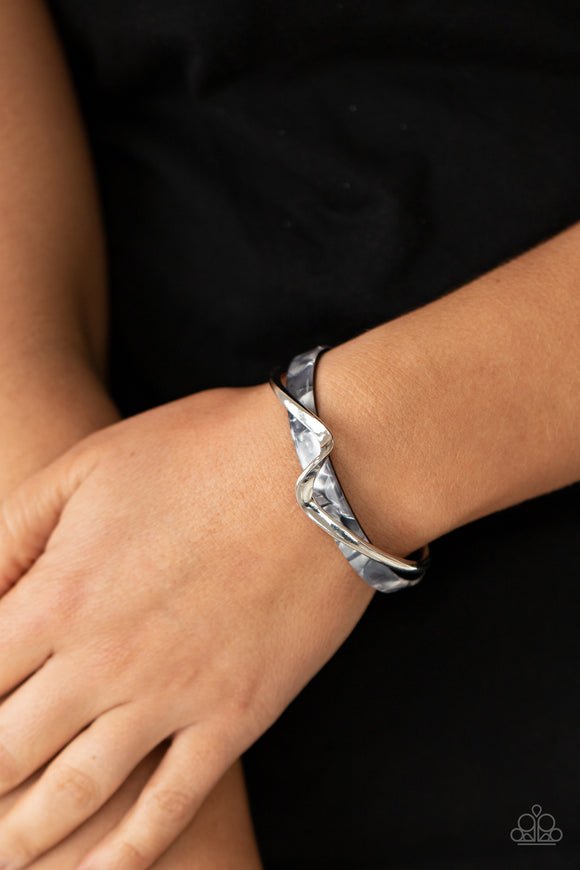 Craveable Curves - Silver - Paparazzi Accessories -  Item #P9BA-SVXX-120XX A flat silver bar delicately curls across a dainty gray shell-like acrylic cuff, creating a whimsical centerpiece around the wrist.  Sold as one individual bracelet.