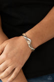 Craveable Curves - Brown - Paparazzi Accessories -   Item #P9BA-BNXX-022XX A flat silver bar delicately curls across a dainty brown shell-like acrylic cuff, creating a whimsical centerpiece around the wrist.  Sold as one individual bracelet.