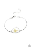 Prairie Paradise - White - Paparazzi Accessories -  Item #P9DA-WTXX-100XX Encased inside an asymmetrical glass casing, a dainty white firework flower centerpiece attaches to two arcing silver bars around the wrist for a whimsical floral look. Features an adjustable clasp closure.  Sold as one individual bracelet.