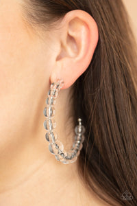 In The Clear - White - Paparazzi Accessories -  Item #P5HO-WTXX-092XX Gradually increasing in size at the center, a glassy collection of white beads are threaded along an oversized hoop for a bubbly effect. Earring attaches to a standard post fitting. Hoop measure approximately 2 1/2" in diameter.  Sold as one pair of hoop earrings.