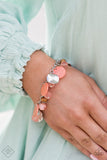 Springtime Springs - Orange - Paparazzi Accessories -  Item #P9ST-OGXX-009ZZ Springtime charms of shiny and soft beads and pearl-like discs in lovely tones of Burnt Coral sway from a silver chain. Accents of sparkly, wavy silver discs and wooden beads bring it down to earth as the fringe wraps around the wrist. Features an adjustable clasp closure..  Sold as one individual bracelet.  2021 APRIL FASHION FIX