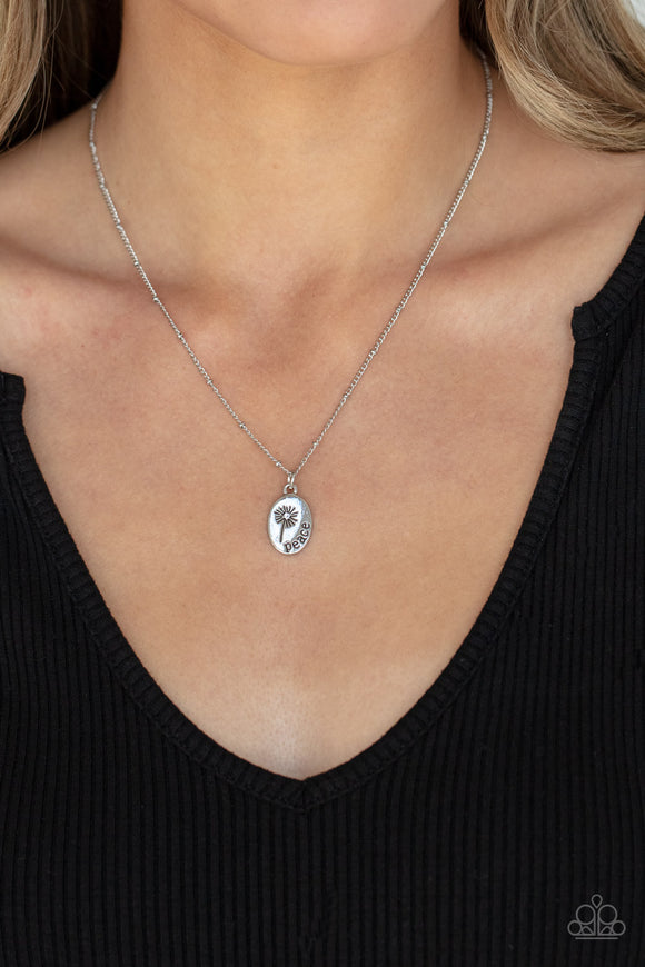 Be The Peace You Seek - Silver - Paparazzi Accessories -   Item #P2WD-SVXX-254XX Featuring a blooming dandelion, a simple silver disc is stamped in the word, 