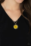 Prairie Promenade - Yellow - Paparazzi Accessories -  Item #P2DA-YWXX-059XX A yellow daisy is encased inside a glassy casing, creating a whimsical floral pendant beneath the collar. Features an adjustable clasp closure.  Sold as one individual necklace. Includes one pair of matching earrings.